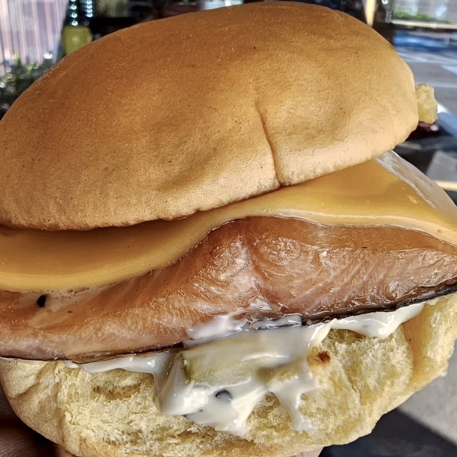 A trout fillet burger with melted cheese